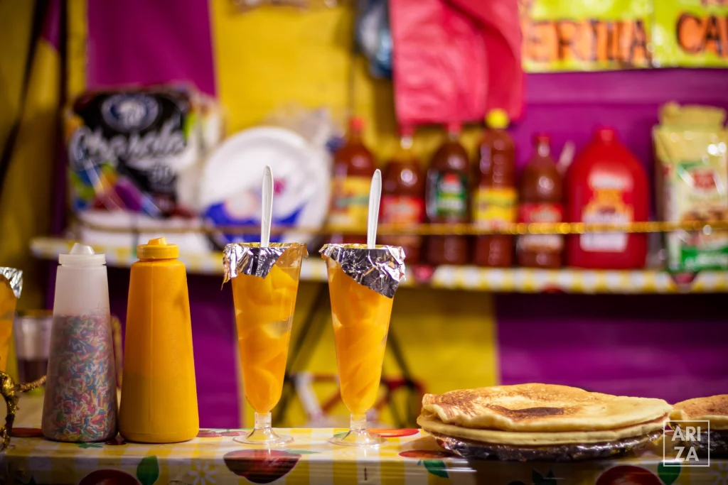 two straws in two glasses of orange juices on a bar 