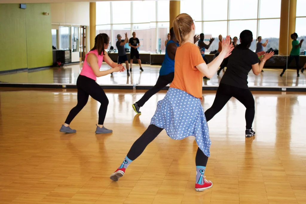 people dancing infront of a mirror