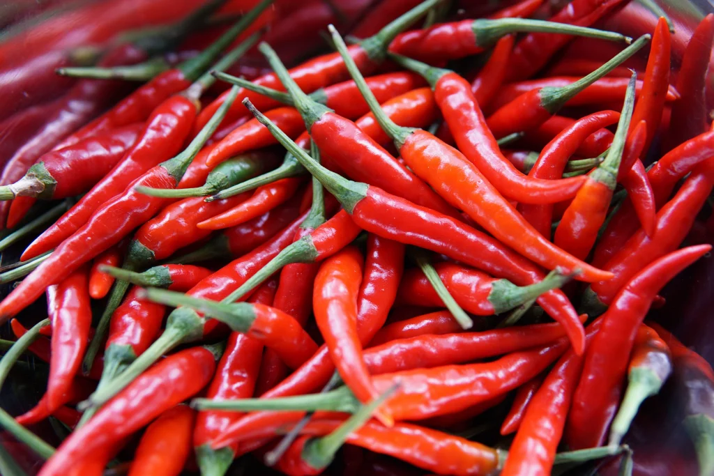 longer red peppers on a table