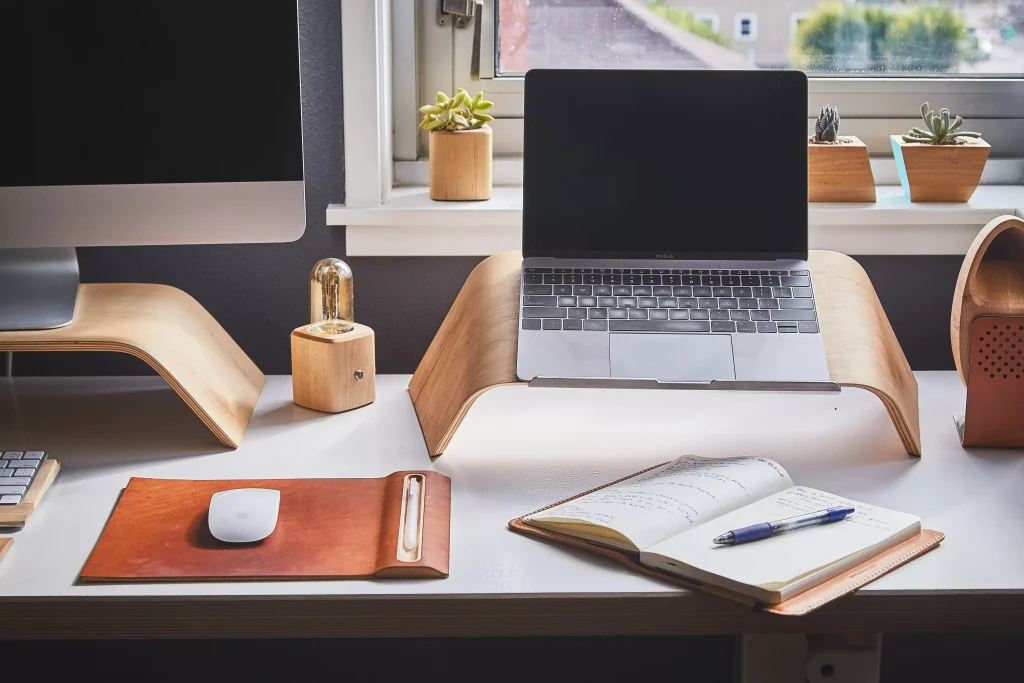 a laptop next to a notebook