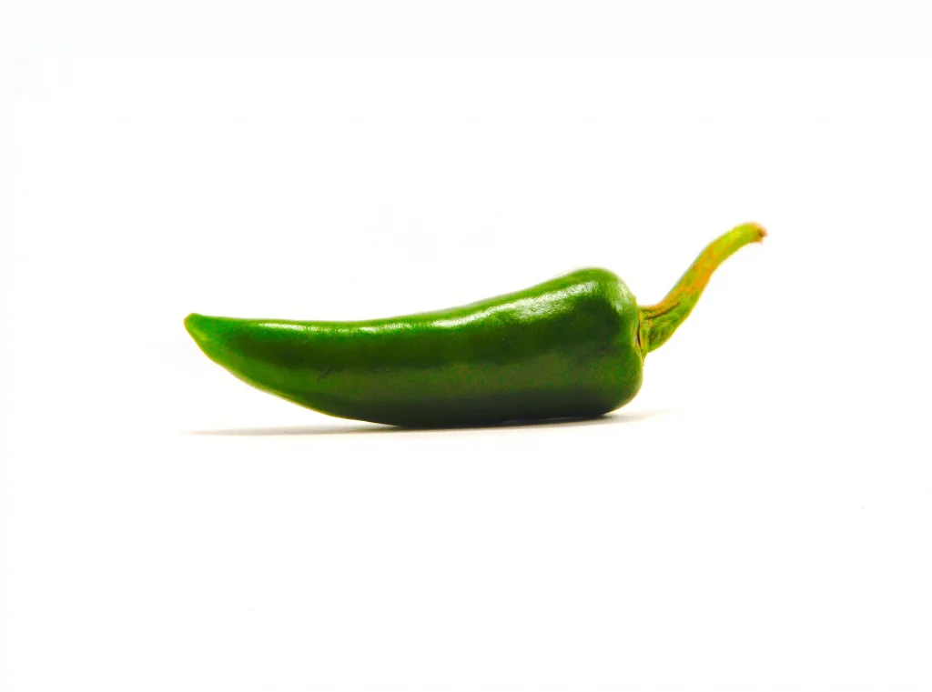 a green pepper infront of a white background