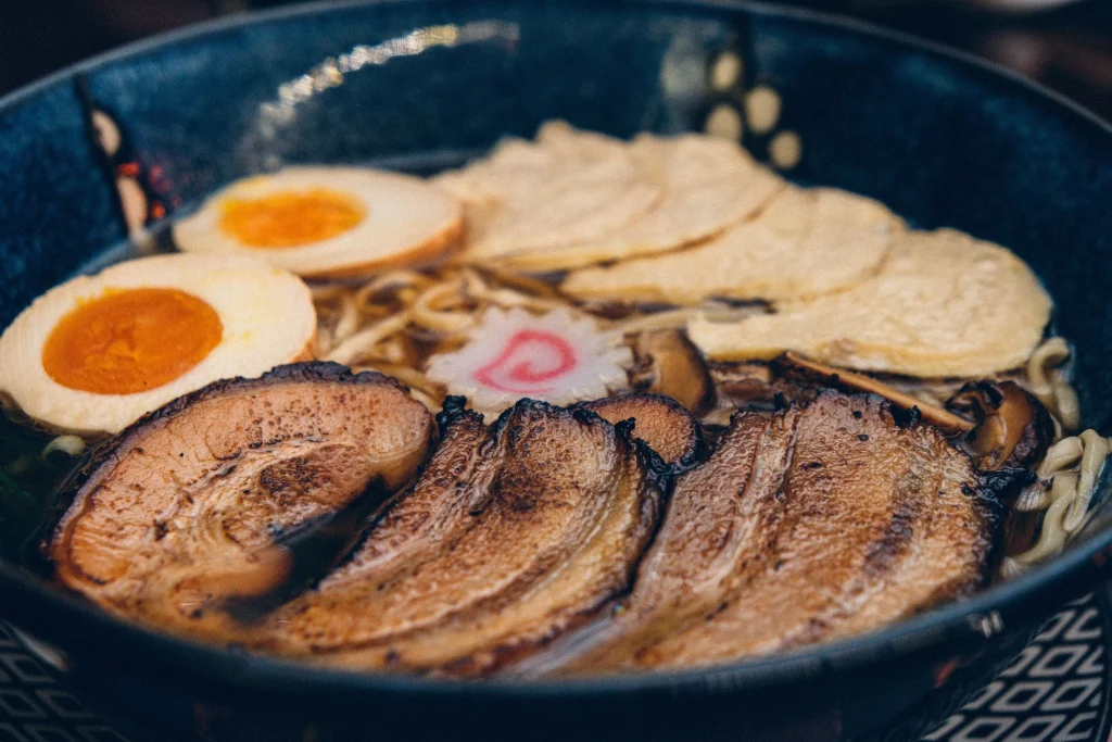 eggs and bacon in a dark blue bowl