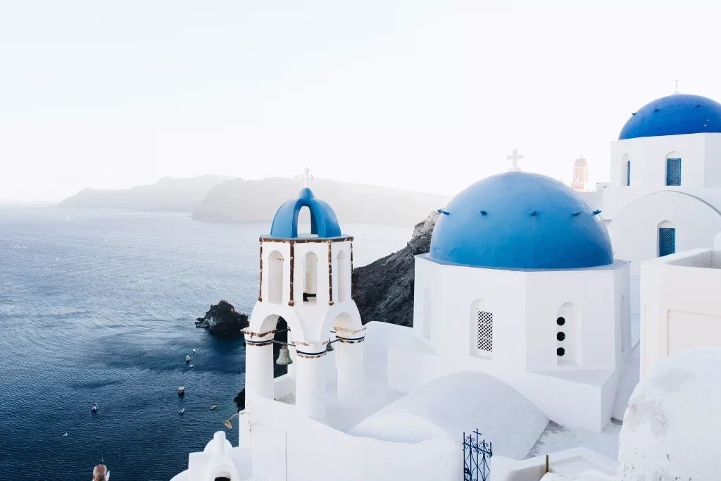 white houses with blue roofs on the beach