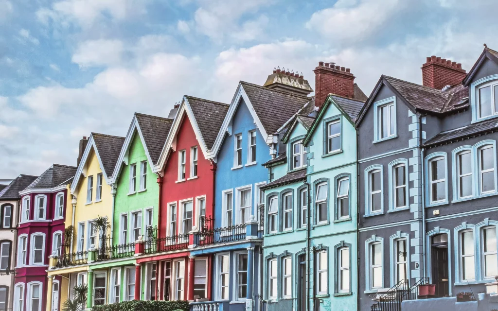 yellow blue green and red houses next to each other