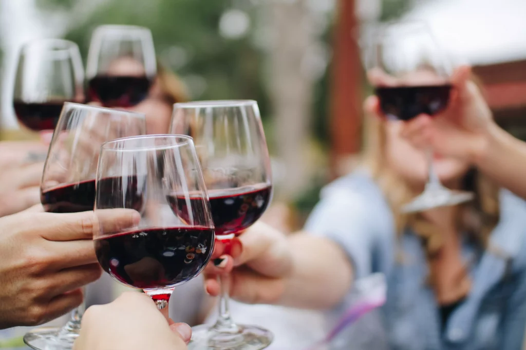 people with wine glasses making a toast