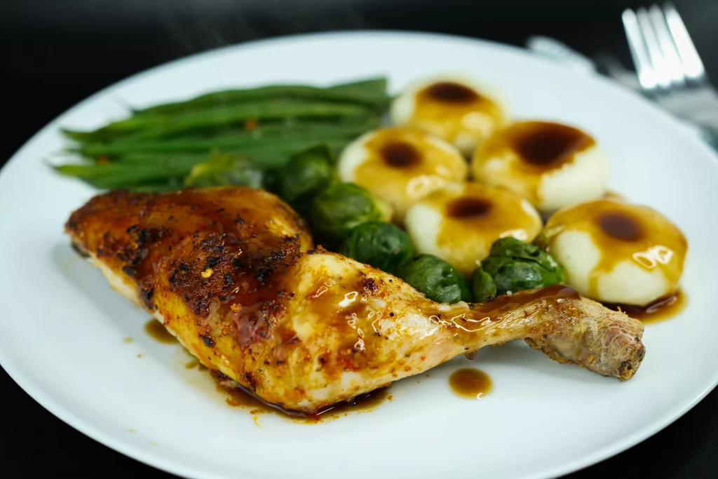 chicken breast and green salad on a white porculan plate