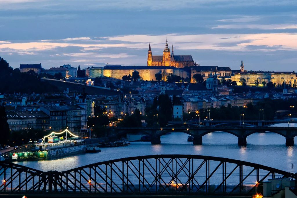 a picture taken at night of a beautiful city with bridges