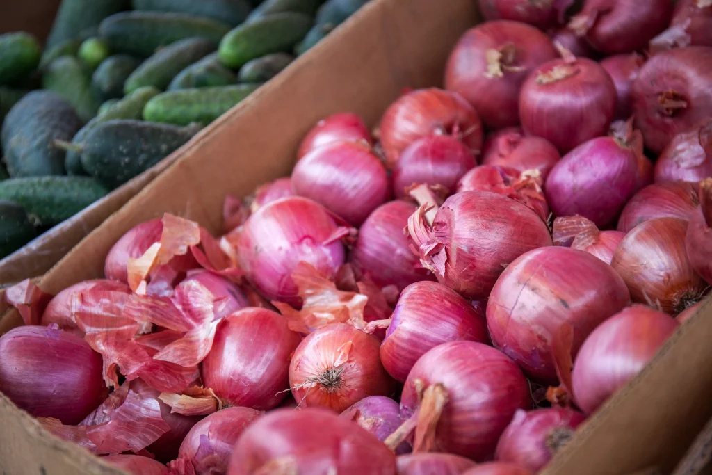 little purple onions organized in a box