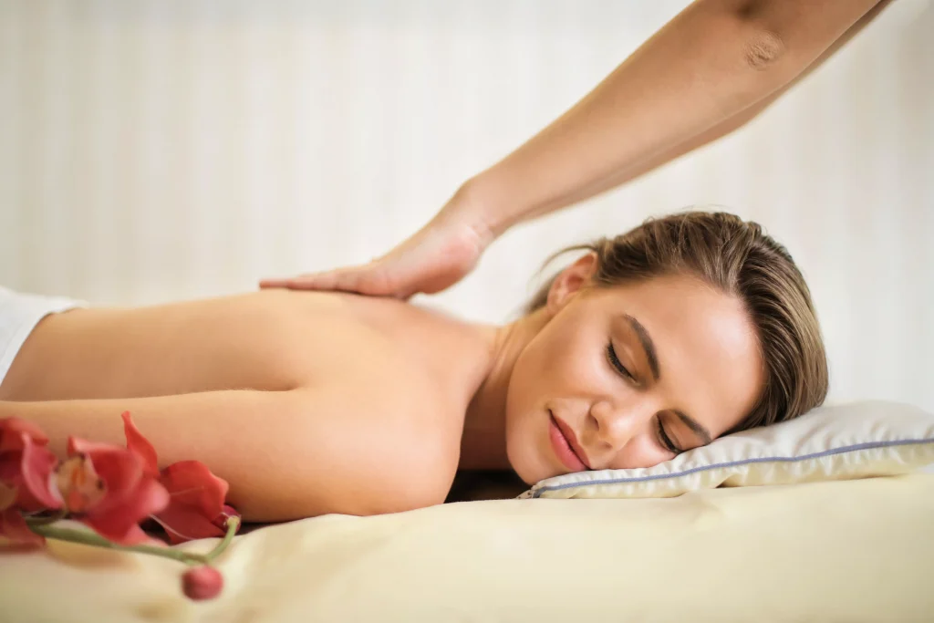 a person massaging a women in a spa