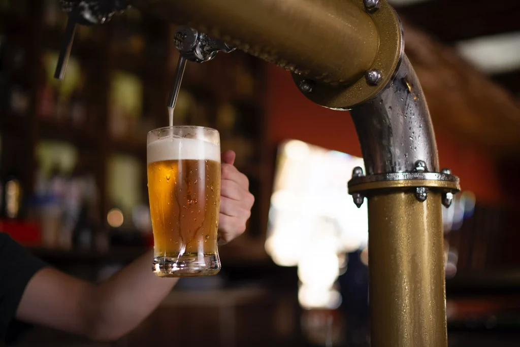 pouring beer from a barrel