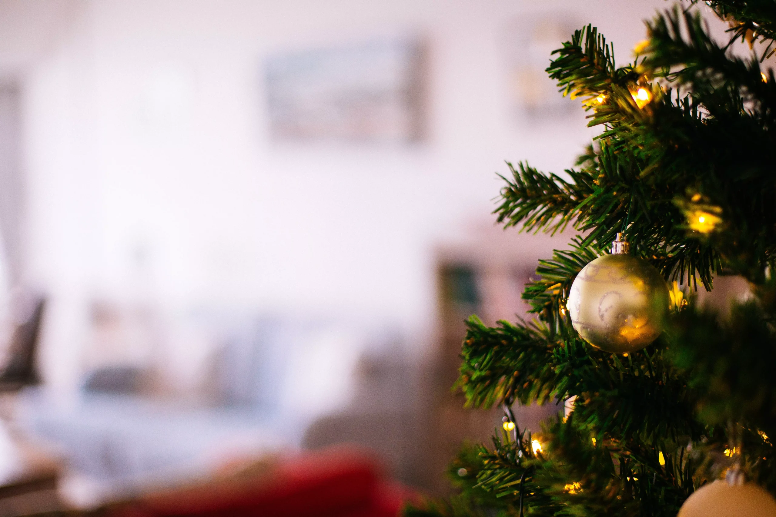 golden Christmas tree ornaments on a tree