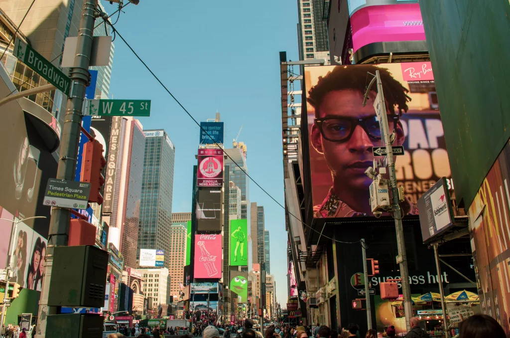 a lot of bilboards photographed in the middle of the city