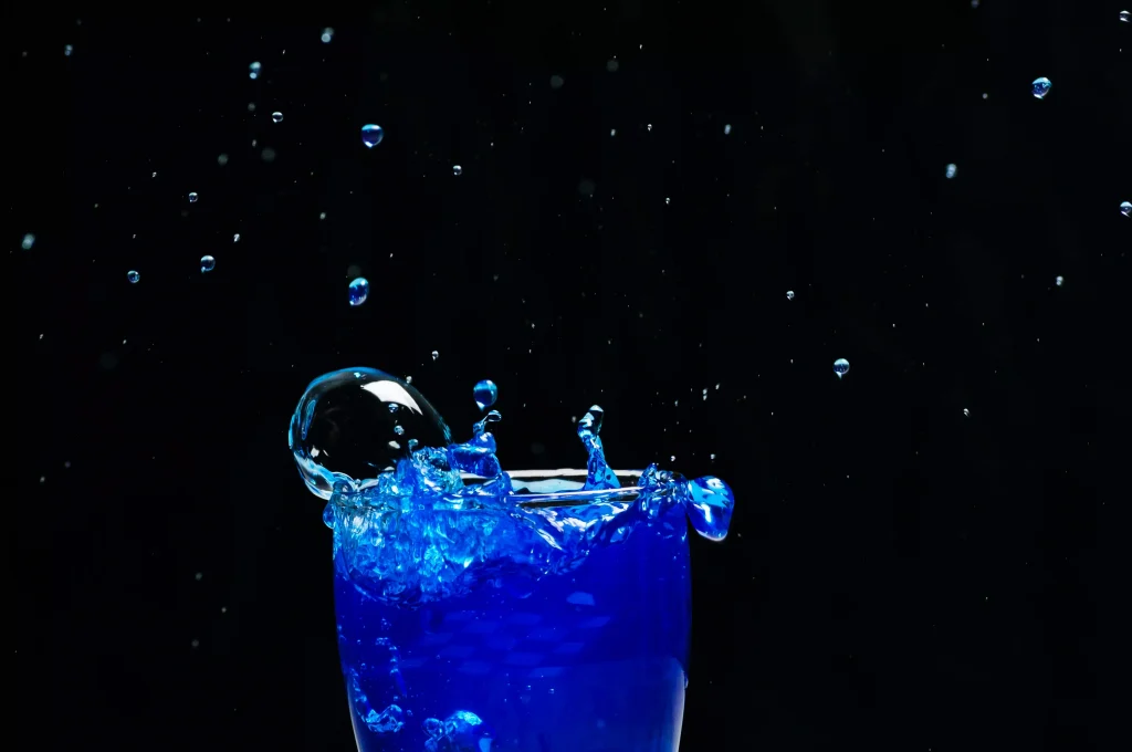 a blue color drink in a glass