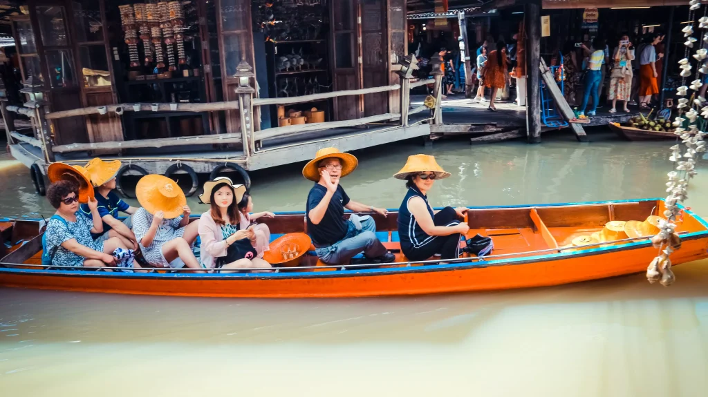 people in a boat on a river with yellow hats on