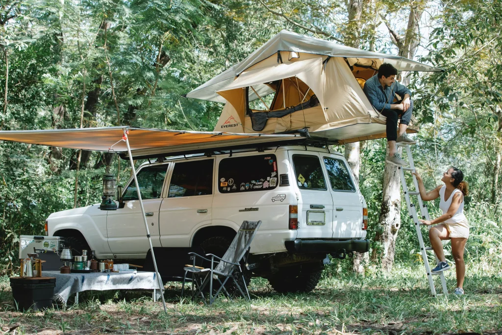 a white suv with a tent on it