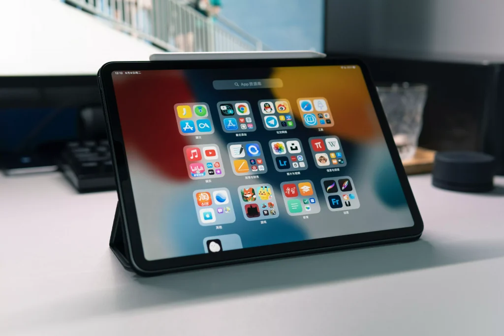 a tablet on a desk with apps on it