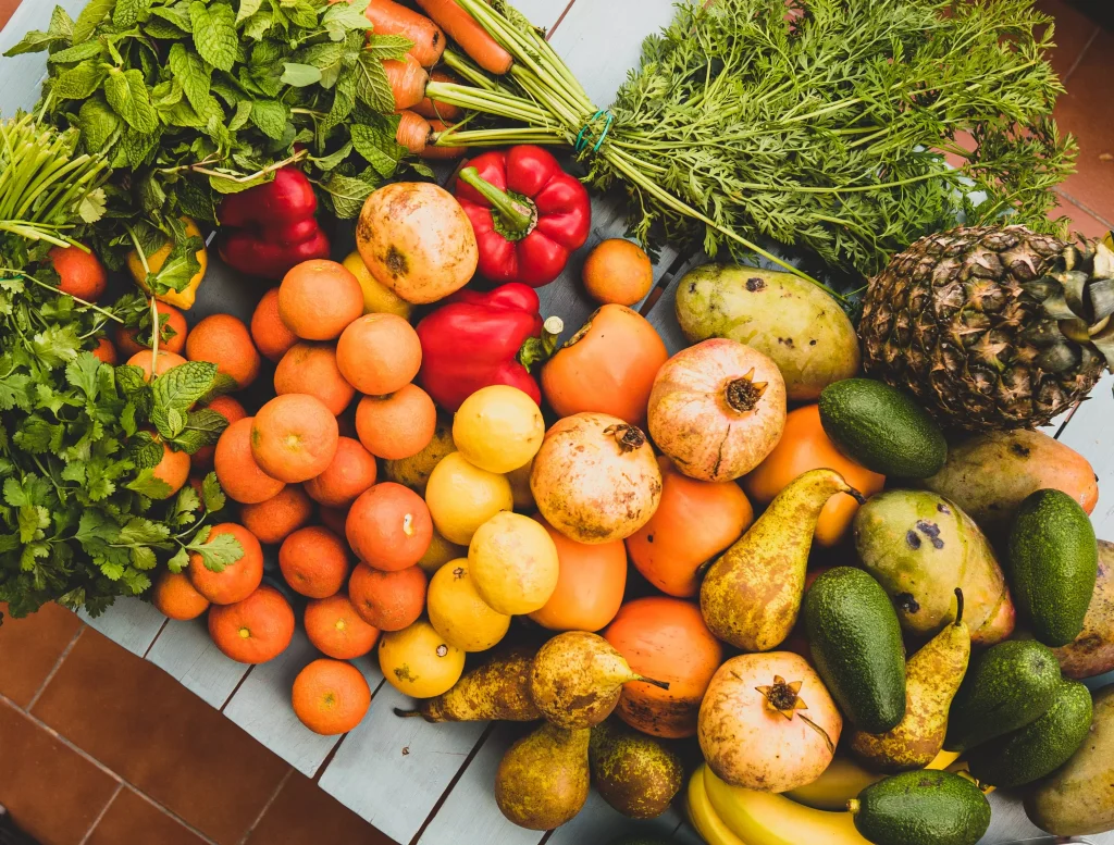 different types of fruit and vegetables spilled on a table