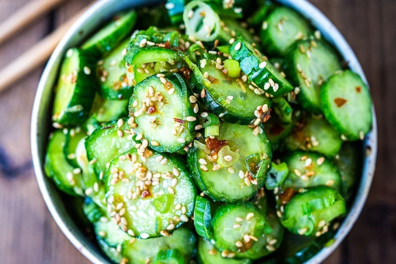 cut up cucumbers in a white bowl