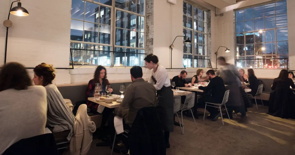 interior of a restaurant with white walls and big windows