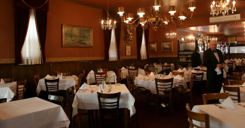 interior of a restaurant with white table cloths 