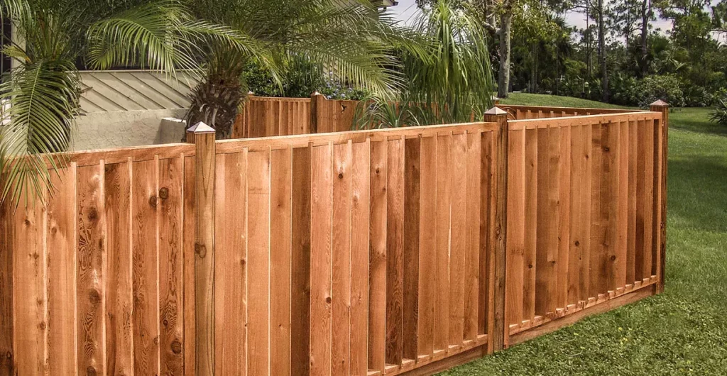 a wooden fence on a green field