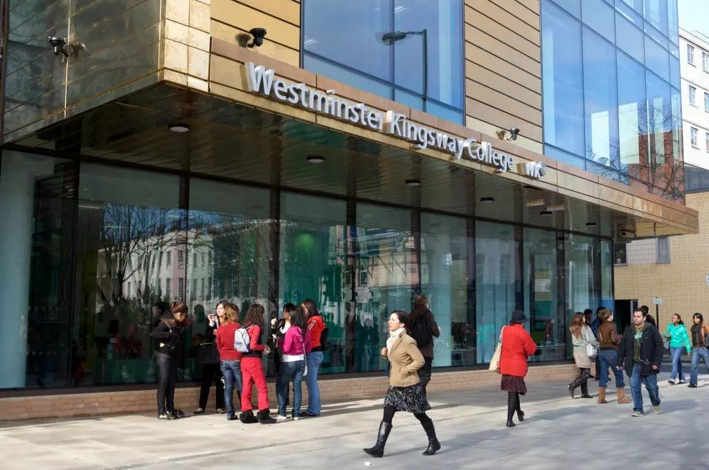 a building with glass and people infront of it