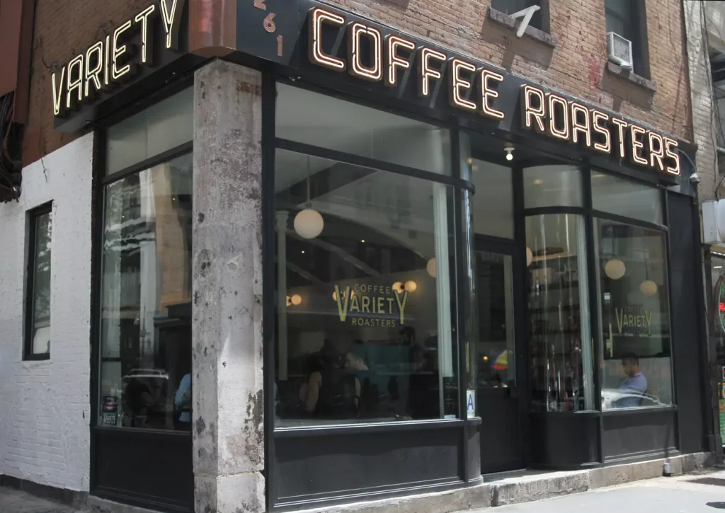 a coffee shop with big glasses on the corner of a street