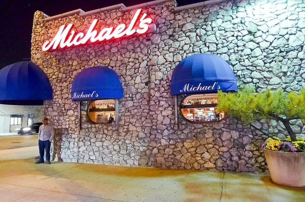 a building made of stones with a sign that says Michaels