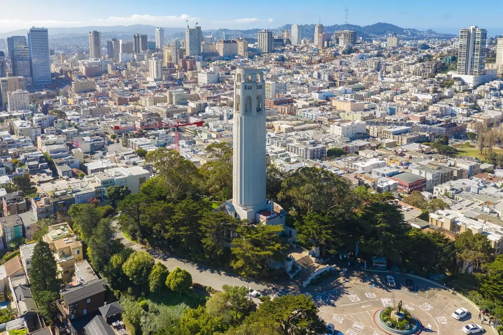 a big white tower in the middle of a city