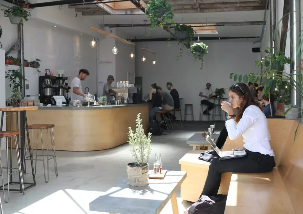 inside of a coffee shop with a wooden bar