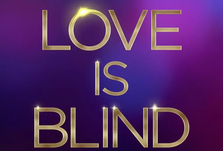 love is blind written in golden letters