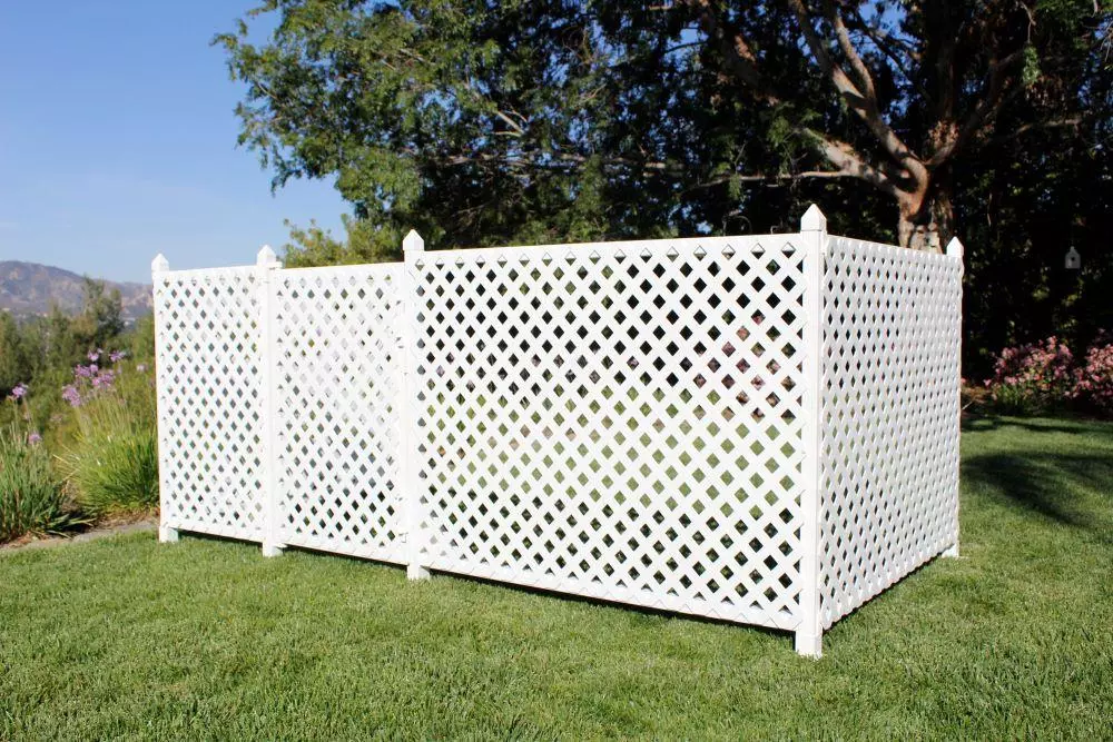 a white wooden fence with holes