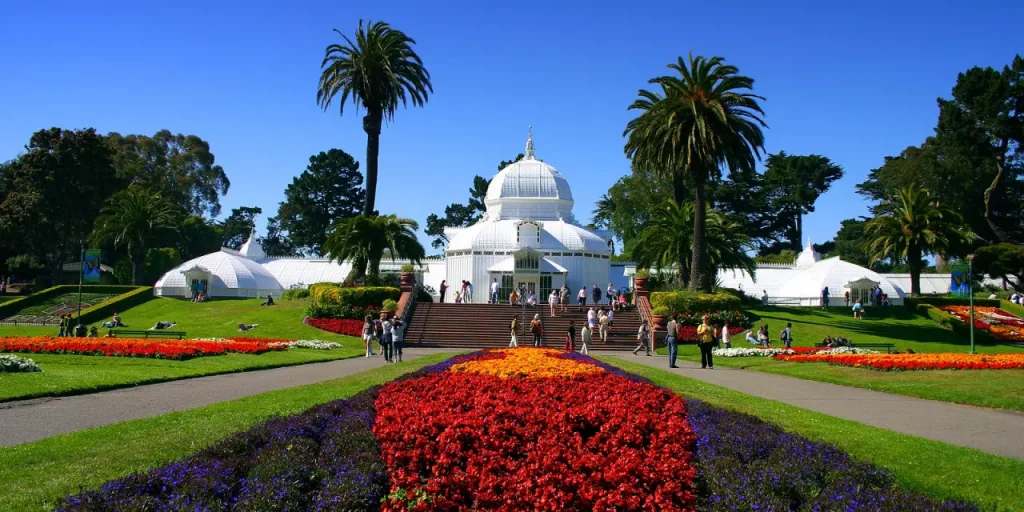 a white building with flowers infront of it