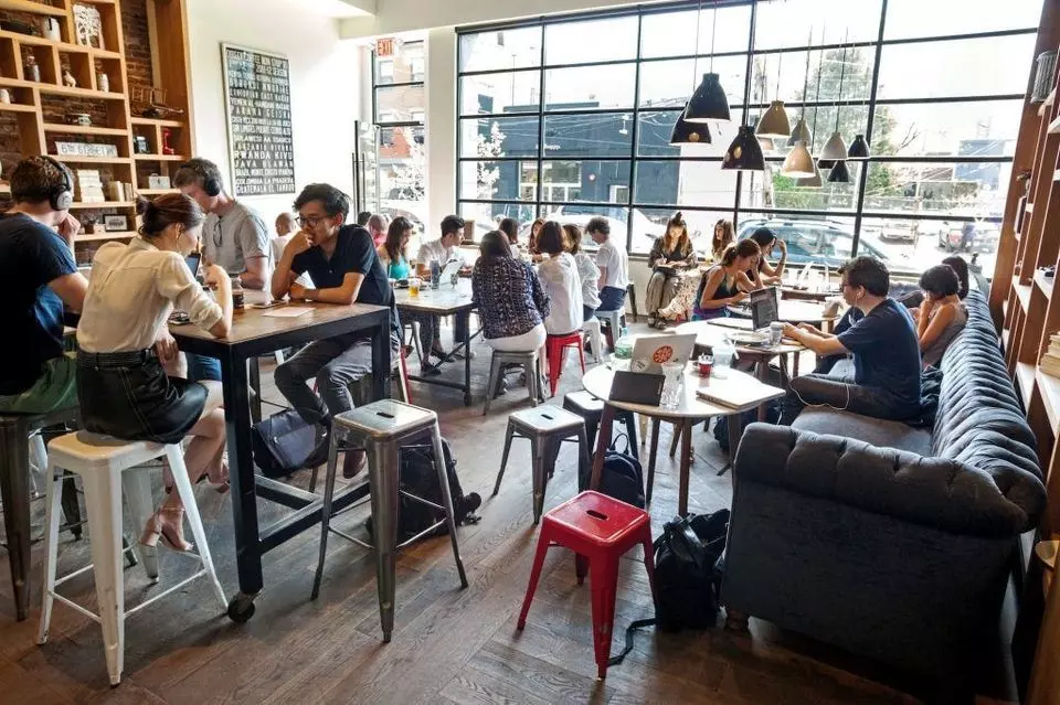 people inside of a restaurant eating and drinking