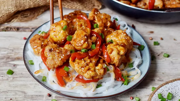 chicken with ketchup on a white plate