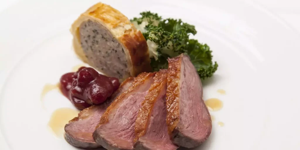 cooked meat and bread on a white plate