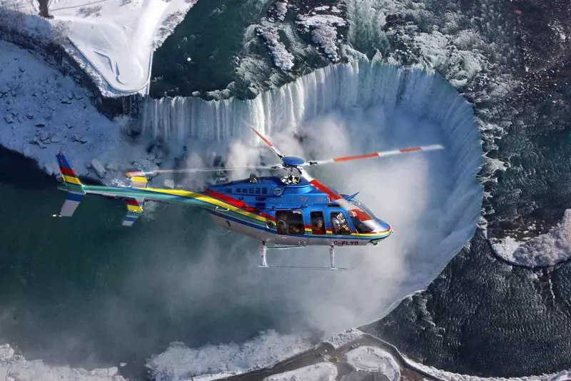 a helicopter above a watefall