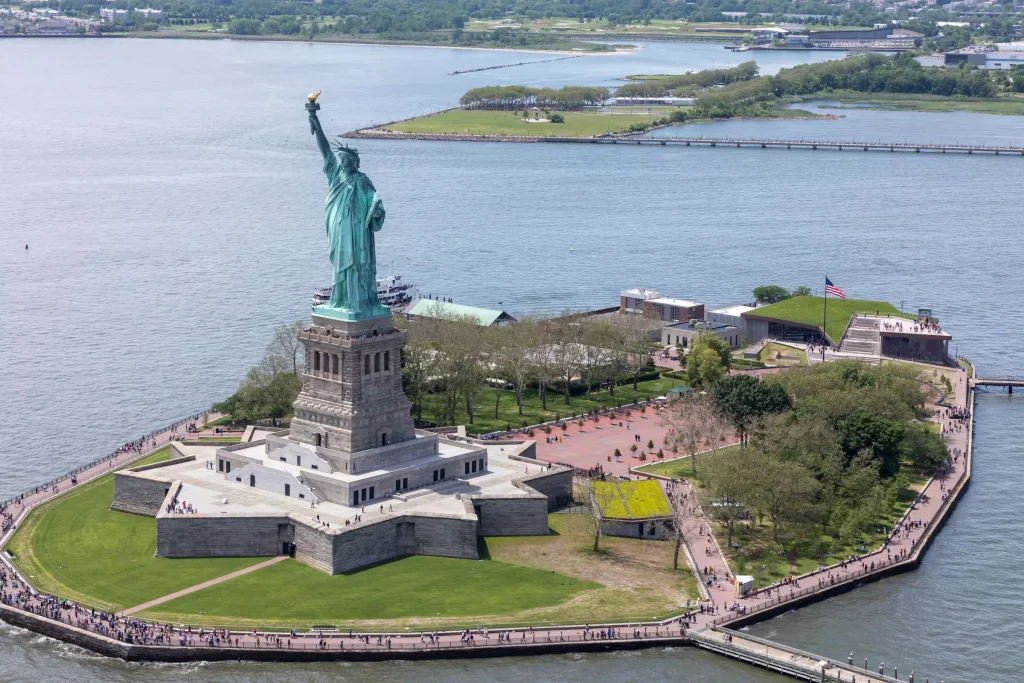 a statue on an island in the middle of the sea