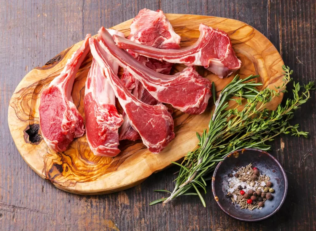 red meat on a cutting board being prepared for cooking