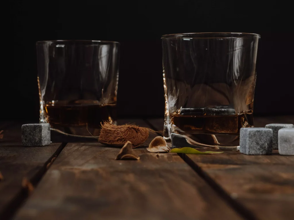 two glasses next to some sugar cubes