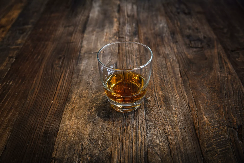 a small glass on a wooden table