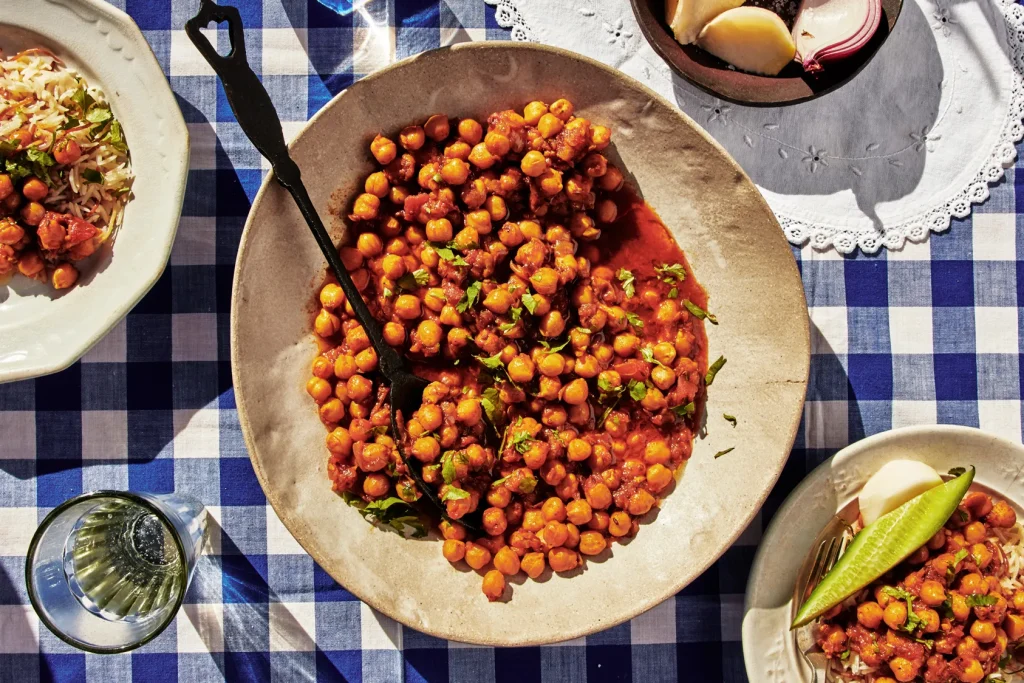 beans and salad with a drink next to it