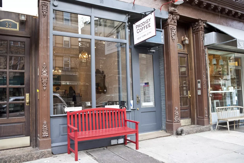 a red chair infront of a coffee shop