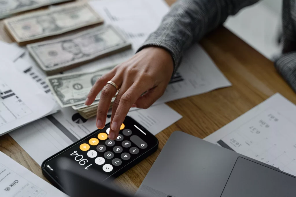 a guy in a grey shirt using the calculator