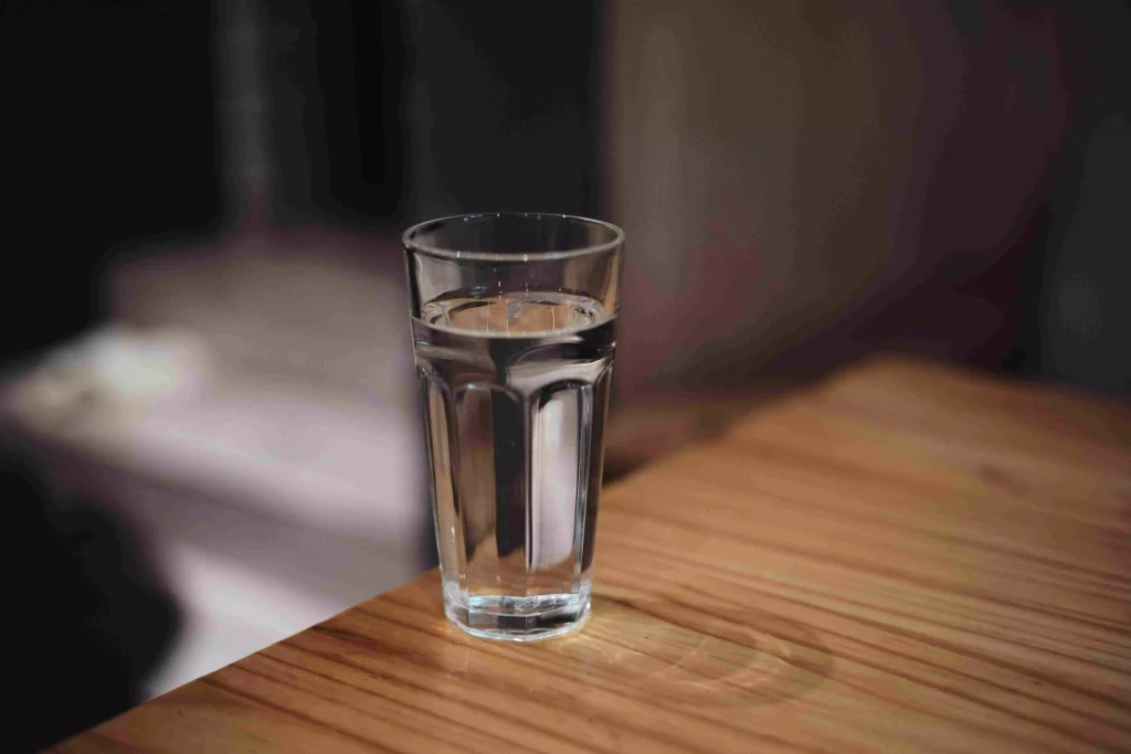 a glass of water on a wooden table