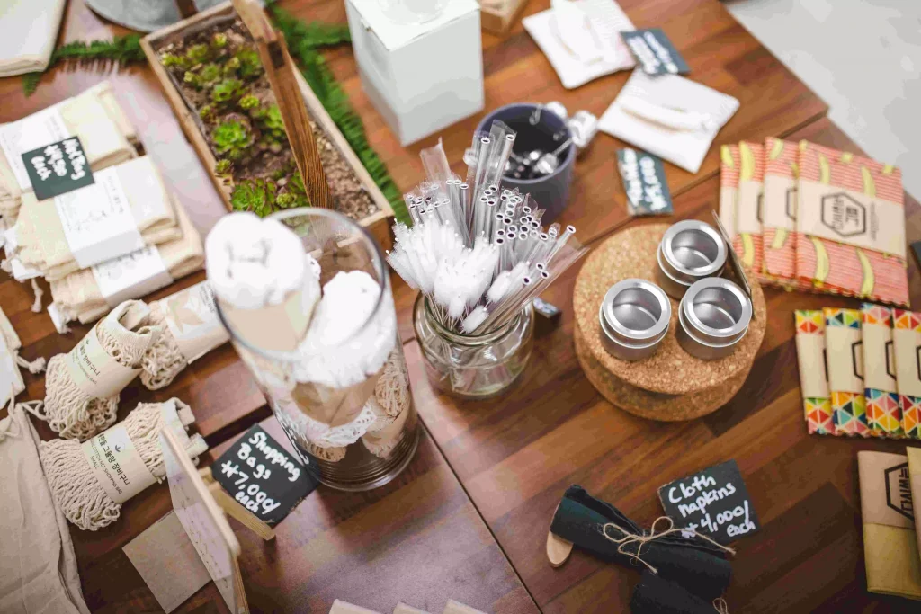 a wooden table crowded with small items