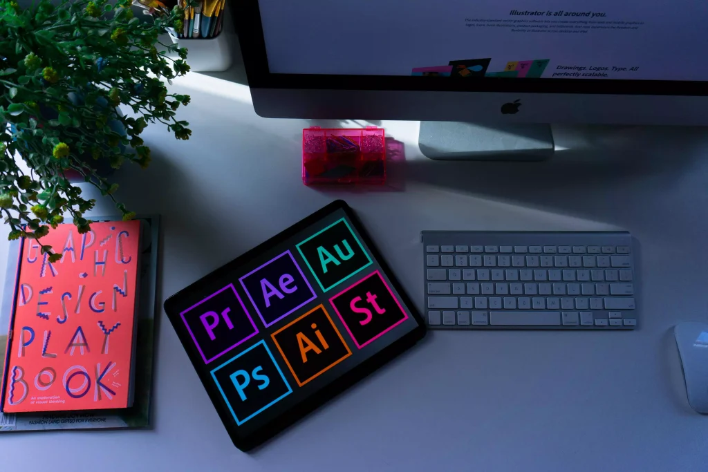 an office desk with a plant and a notebook on it