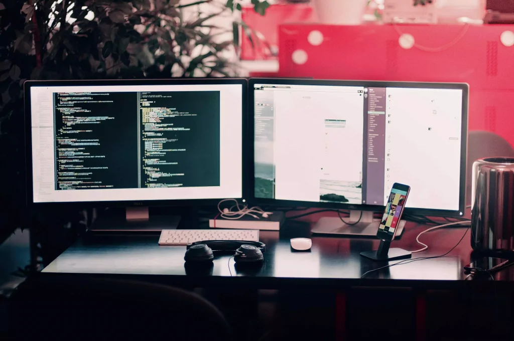 two monitors with on an office desk