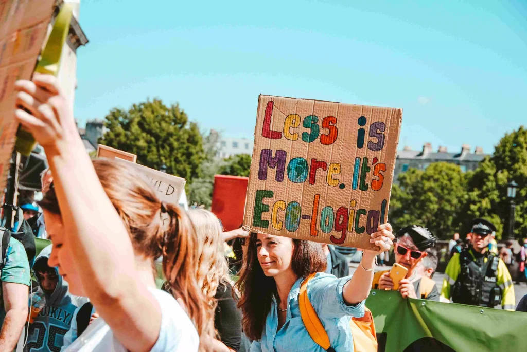 a women holding a sign in a park