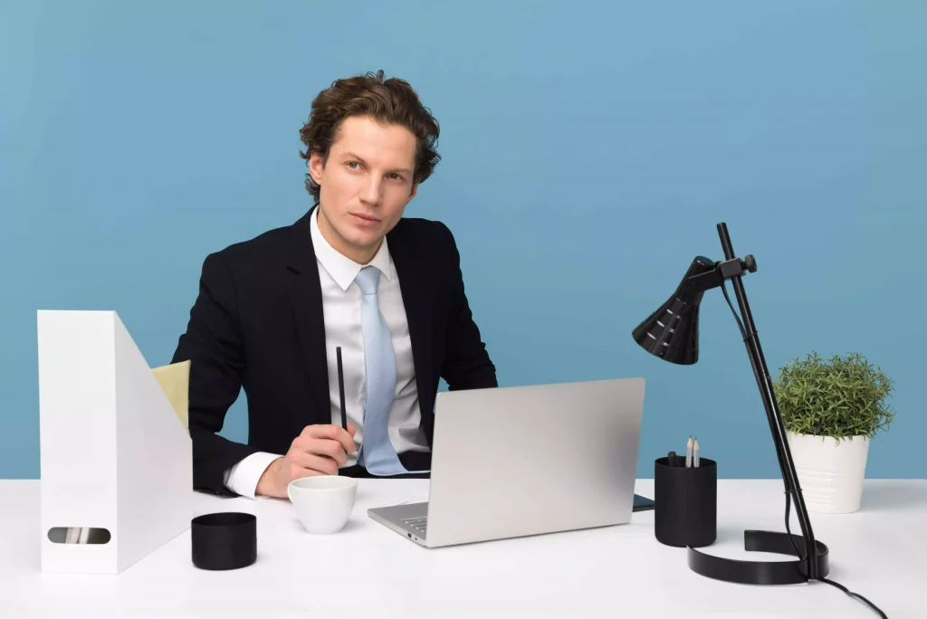 a man in a suit working on his laptop